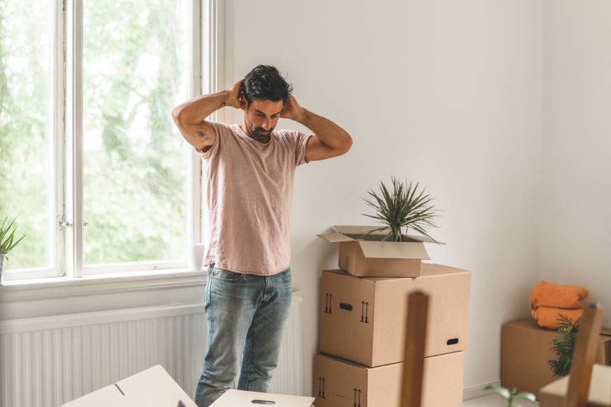 Man worried about moving scams as he packs the contents of his home for moving.