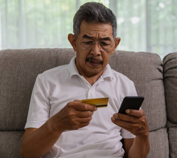 Man using his credit card with buying a product online with his phone.